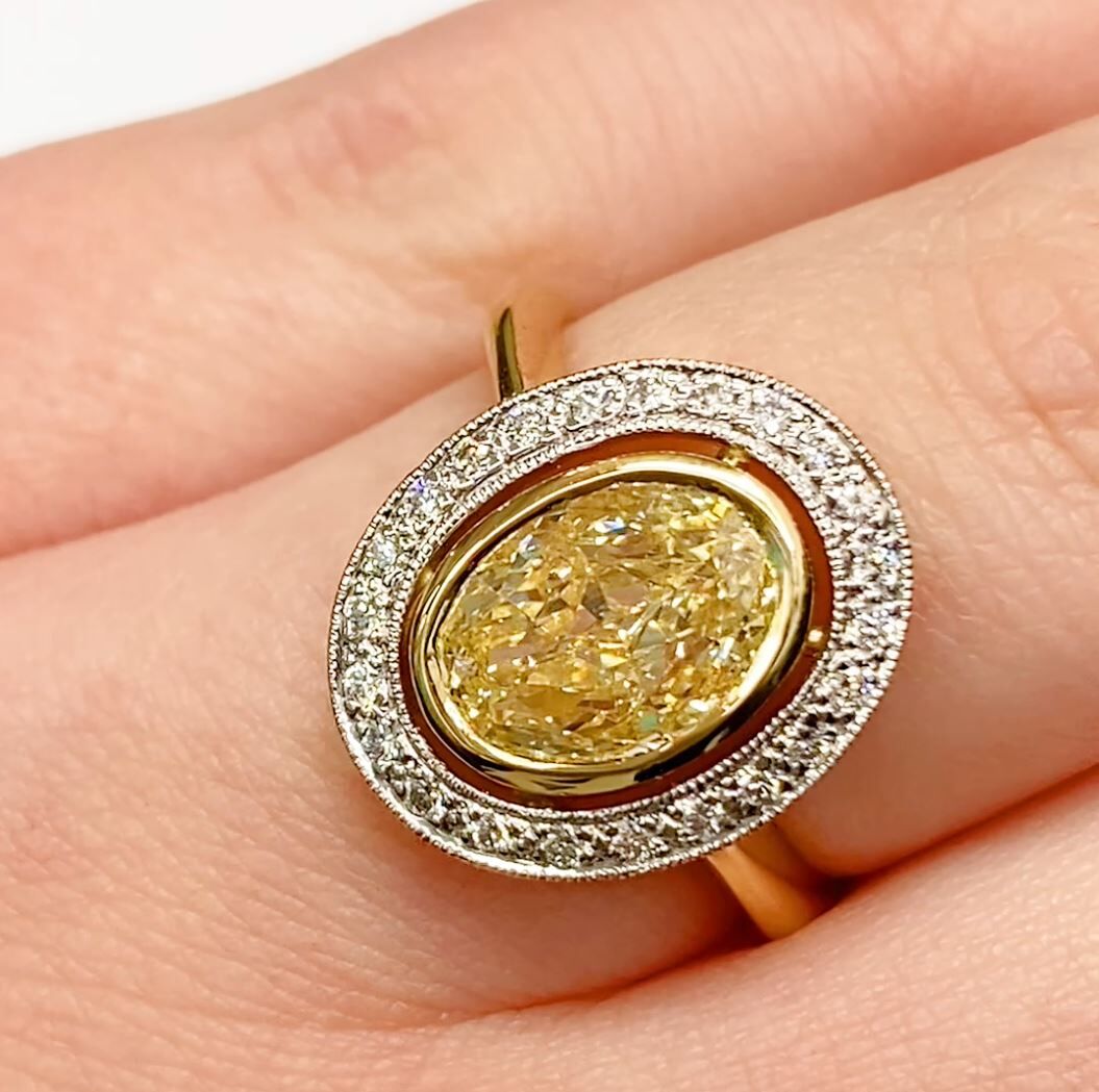 Brilliant cut oval yellow diamond halo ring